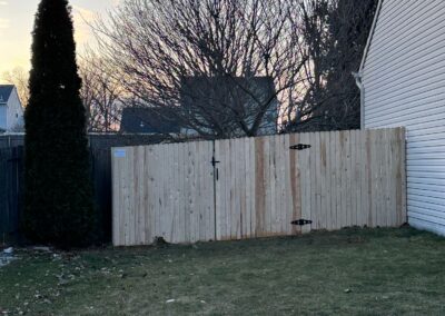 Classic wood fence installed by Fence Imperial, demonstrating elegant craftsmanship and natural beauty for enhancing property aesthetics.