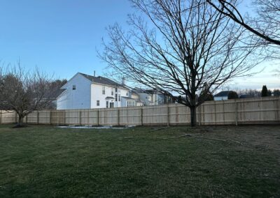 Classic wood fence installed by Fence Imperial, demonstrating elegant craftsmanship and natural beauty for enhancing property aesthetics.