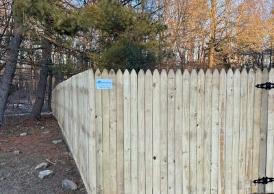 Classic wood fence installed by Fence Imperial, demonstrating elegant craftsmanship and natural beauty for enhancing property aesthetics.