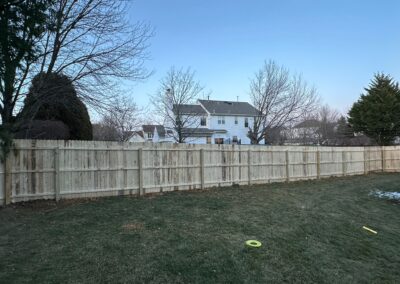 Classic wood fence installed by Fence Imperial, demonstrating elegant craftsmanship and natural beauty for enhancing property aesthetics.