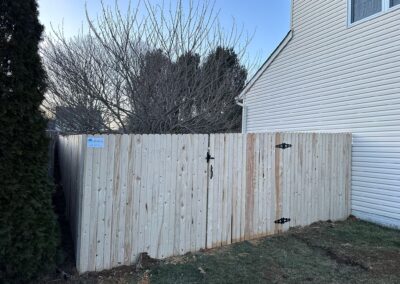 Classic wood fence installed by Fence Imperial, demonstrating elegant craftsmanship and natural beauty for enhancing property aesthetics.