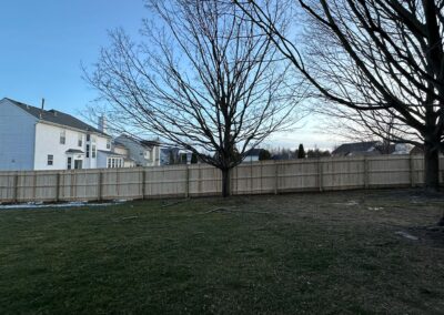 Classic wood fence installed by Fence Imperial, demonstrating elegant craftsmanship and natural beauty for enhancing property aesthetics.