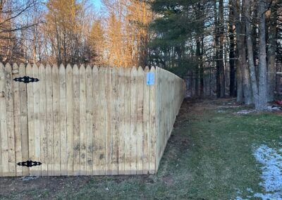 Classic wood fence installed by Fence Imperial, demonstrating elegant craftsmanship and natural beauty for enhancing property aesthetics.