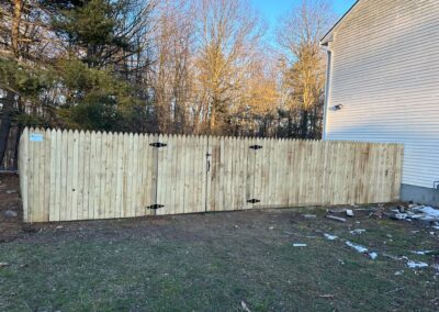 Classic wood fence installed by Fence Imperial, demonstrating elegant craftsmanship and natural beauty for enhancing property aesthetics.