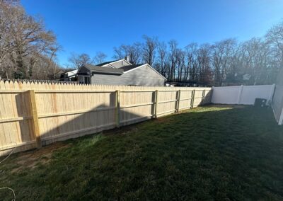 Classic wood fence installed by Fence Imperial, demonstrating elegant craftsmanship and natural beauty for enhancing property aesthetics.