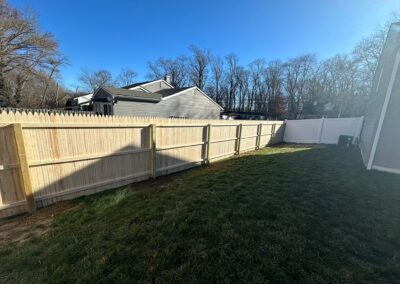 Classic wood fence installed by Fence Imperial, demonstrating elegant craftsmanship and natural beauty for enhancing property aesthetics