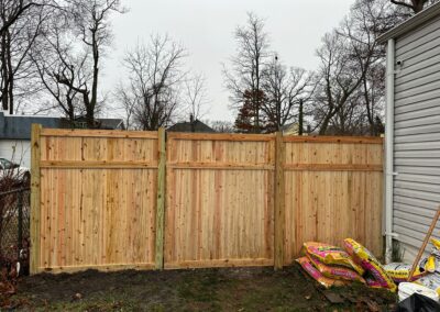 Classic wood fence installed by Fence Imperial, demonstrating elegant craftsmanship and natural beauty for enhancing property aesthetics