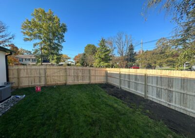 Classic wood fence installed by Fence Imperial, demonstrating elegant craftsmanship and natural beauty for enhancing property aesthetics