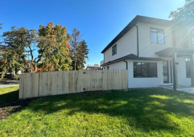 Classic wood fence installed by Fence Imperial, demonstrating elegant craftsmanship and natural beauty for enhancing property aesthetics.