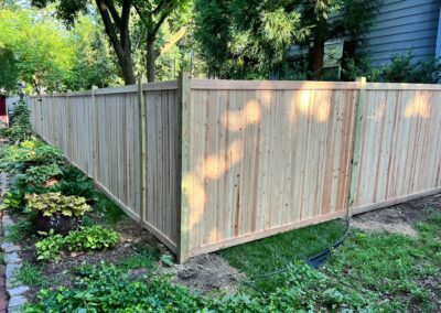 Classic wood fence installed by Fence Imperial, demonstrating elegant craftsmanship and natural beauty for enhancing property aesthetics.