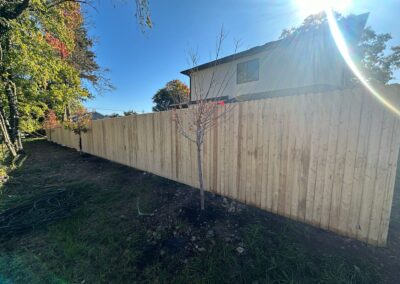 Classic wood fence installed by Fence Imperial, demonstrating elegant craftsmanship and natural beauty for enhancing property aesthetics.