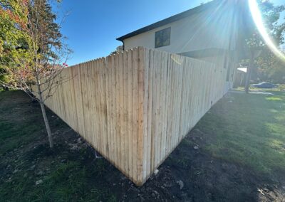 Classic wood fence installed by Fence Imperial, demonstrating elegant craftsmanship and natural beauty for enhancing property aesthetics.