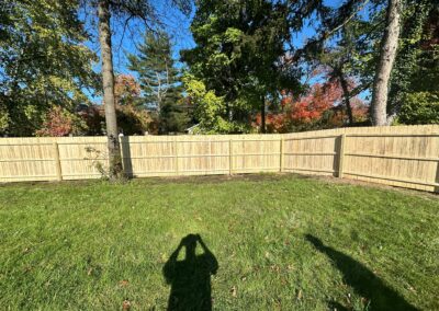 Classic wood fence installed by Fence Imperial, demonstrating elegant craftsmanship and natural beauty for enhancing property aesthetics.