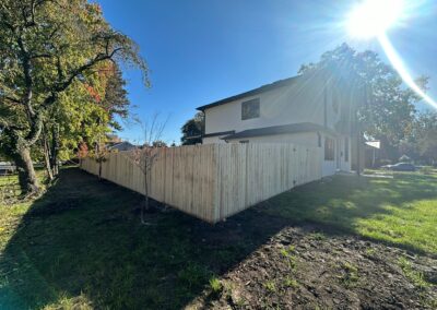 Classic wood fence installed by Fence Imperial, demonstrating elegant craftsmanship and natural beauty for enhancing property aesthetics.