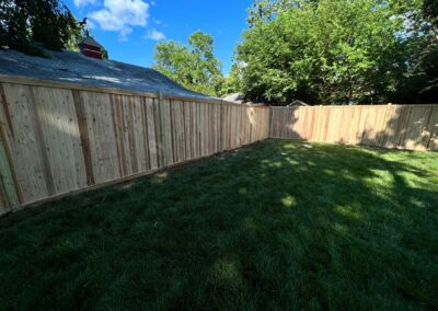 Classic wood fence installed by Fence Imperial, demonstrating elegant craftsmanship and natural beauty for enhancing property aesthetics.