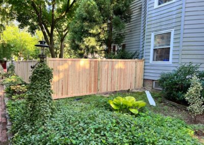 Classic wood fence installed by Fence Imperial, demonstrating elegant craftsmanship and natural beauty for enhancing property aesthetics.