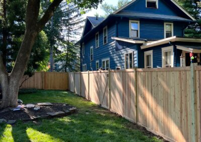 Classic wood fence installed by Fence Imperial, demonstrating elegant craftsmanship and natural beauty for enhancing property aesthetics.