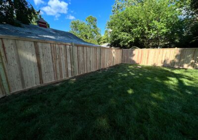 Classic wood fence installed by Fence Imperial, demonstrating elegant craftsmanship and natural beauty for enhancing property aesthetics.