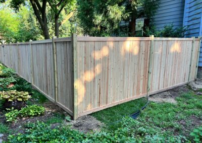 Classic wood fence installed by Fence Imperial, demonstrating elegant craftsmanship and natural beauty for enhancing property aesthetics.