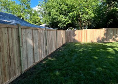 Classic wood fence installed by Fence Imperial, demonstrating elegant craftsmanship and natural beauty for enhancing property aesthetics.