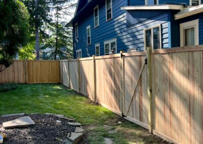 Classic wood fence installed by Fence Imperial, demonstrating elegant craftsmanship and natural beauty for enhancing property aesthetics.