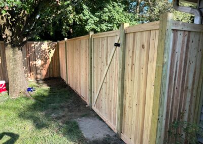 Classic wood fence installed by Fence Imperial, demonstrating elegant craftsmanship and natural beauty for enhancing property aesthetics.