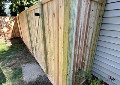 Classic wood fence installed by Fence Imperial, demonstrating elegant craftsmanship and natural beauty for enhancing property aesthetics.