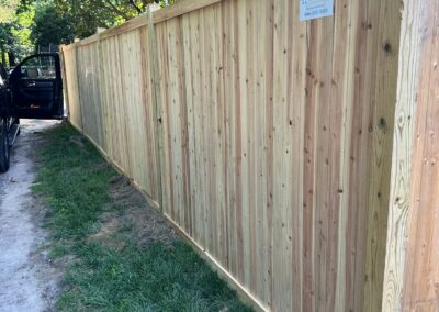 Classic wood fence installed by Fence Imperial, demonstrating elegant craftsmanship and natural beauty for enhancing property aesthetics.