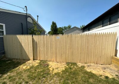 Classic wood fence installed by Fence Imperial, demonstrating elegant craftsmanship and natural beauty for enhancing property aesthetics.