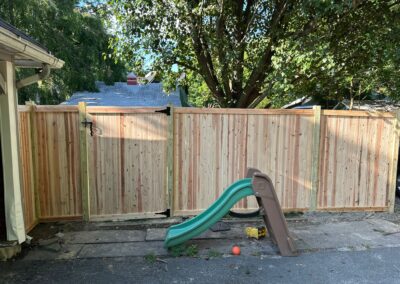 Classic wood fence installed by Fence Imperial, demonstrating elegant craftsmanship and natural beauty for enhancing property aesthetics.