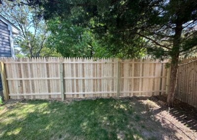 Classic wood fence installed by Fence Imperial, demonstrating elegant craftsmanship and natural beauty for enhancing property aesthetics.