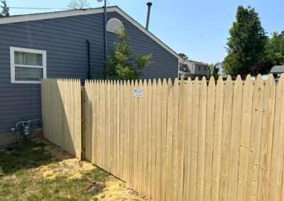 Classic wood fence installed by Fence Imperial, demonstrating elegant craftsmanship and natural beauty for enhancing property aesthetics.