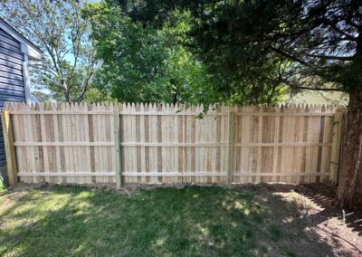 Classic wood fence installed by Fence Imperial, demonstrating elegant craftsmanship and natural beauty for enhancing property aesthetics.