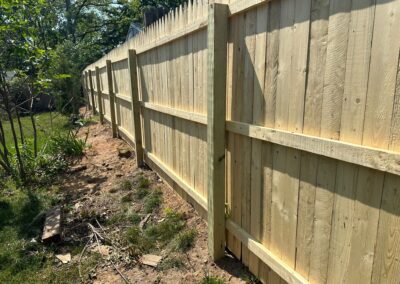 Classic wood fence installed by Fence Imperial, demonstrating elegant craftsmanship and natural beauty for enhancing property aesthetics.