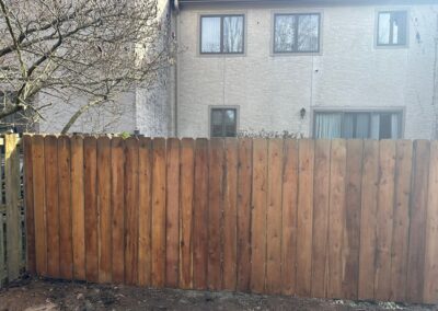 Classic wood fence installed by Fence Imperial, demonstrating elegant craftsmanship and natural beauty for enhancing property aesthetics.