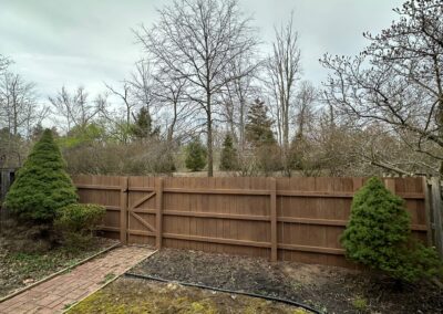 Classic wood fence installed by Fence Imperial, demonstrating elegant craftsmanship and natural beauty for enhancing property aesthetics.