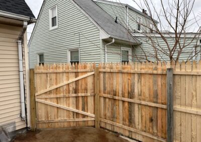 Classic wood fence installed by Fence Imperial, demonstrating elegant craftsmanship and natural beauty for enhancing property aesthetics.