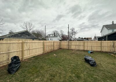 Classic wood fence installed by Fence Imperial, demonstrating elegant craftsmanship and natural beauty for enhancing property aesthetics.